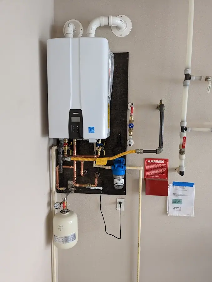 Professional plumber installing copper piping in a Hoosick Falls home